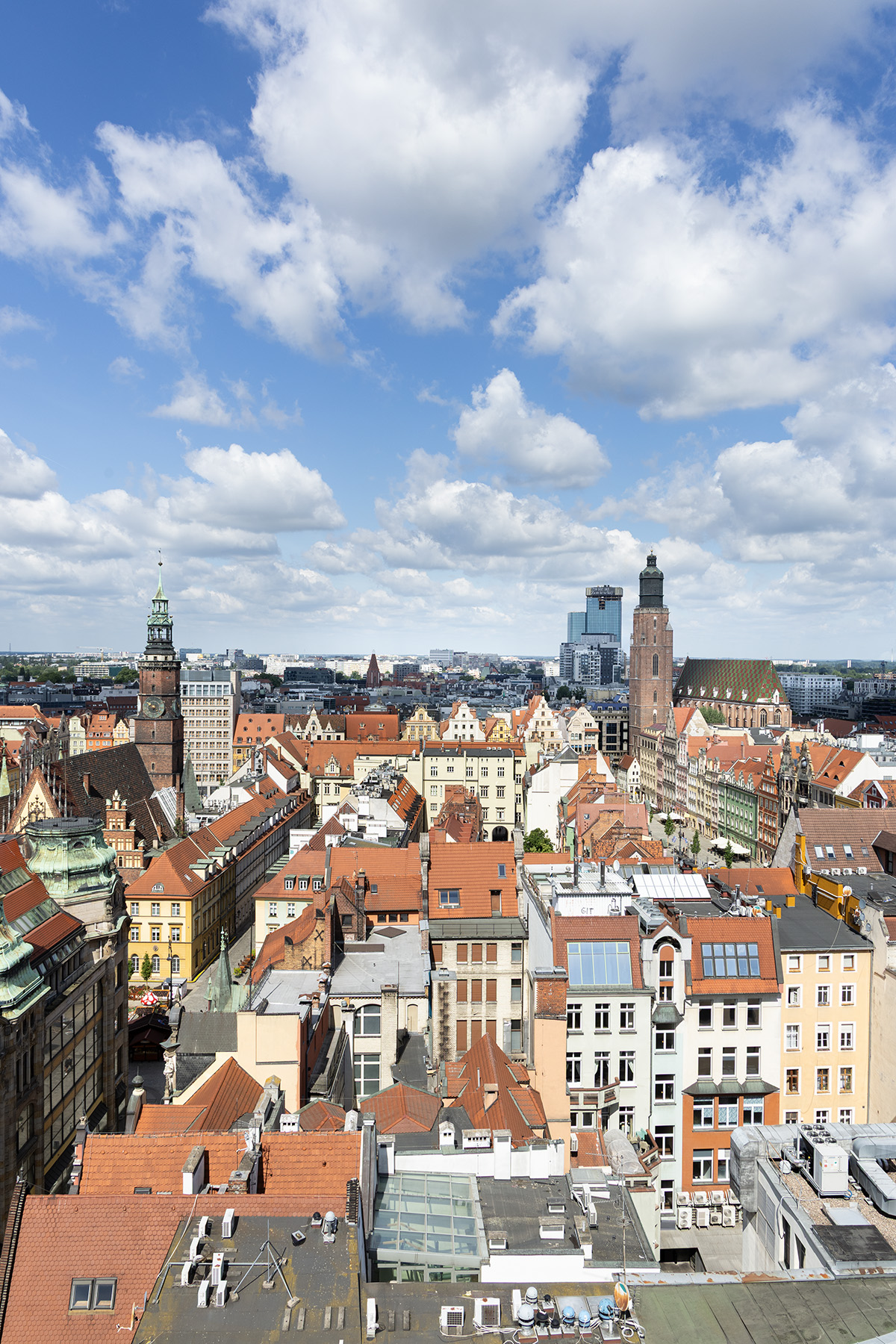 View of Wrocław Old Town from the Bridge of Penitents with historic rooftops and church towers.